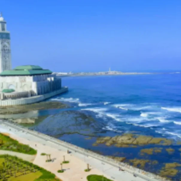Aerial view of the Hassan II Mosque in Casablanca, Morocco, standing by the Atlantic coastline with stunning scenery.