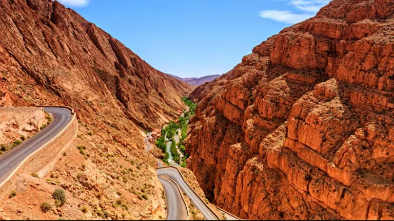 Fes to Marrakech Desert Tour 4 Days 8 Rugged canyon landscape shaped by a winding river, featuring dramatic rock formations in the Dadès Valley by Morocco Fun Tours.