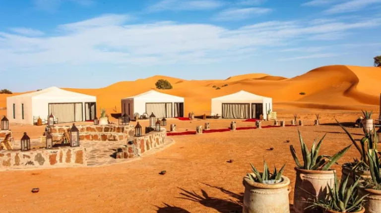 Morocco Itinerary 12 Days 40 Luxury desert camp set among the golden Erg Chebbi sand dunes near Merzouga, Morocco, offering traditional tents surrounded by vast Sahara landscapes.