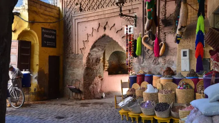 Morocco Itinerary 10 Days 2 Vibrant street scene in the Marrakesh medina with shops, lanterns, and pedestrians creating a lively traditional atmosphere.