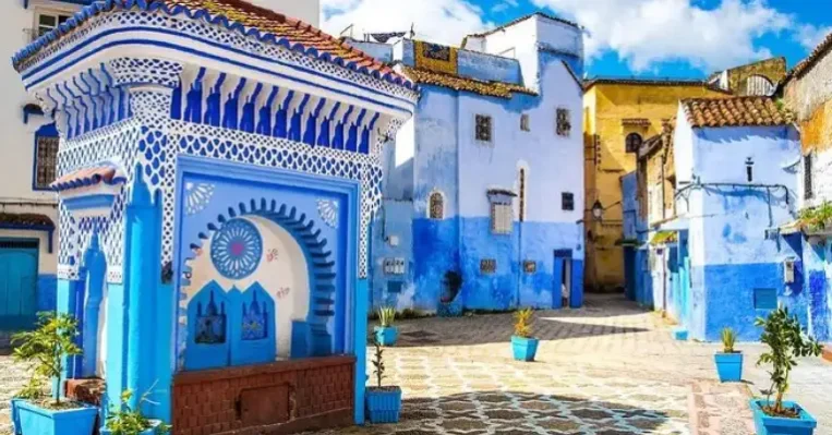 Home 18 Plaza El Hauta in Chefchaouen with blue painted walls, ceramic tilework, and lively atmosphere inside the historic medina