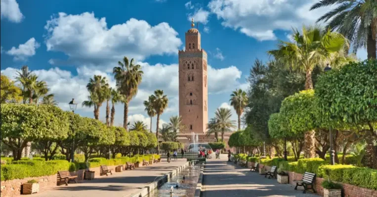 Home 12 Koutoubia Mosque in Marrakesh with historic minaret, palm gardens, and traditional Moorish architecture near the lively medina area