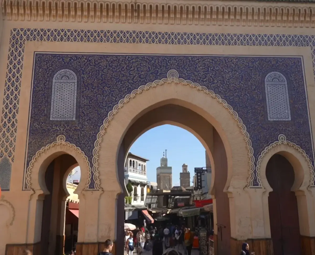 Home 4 Bab Bou Jeloud Blue Gate in Fes displaying intricate Moroccan tilework and the lively entrance to Fes el Bali medina